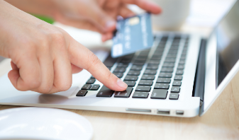 hand-with-credit-card-laptop